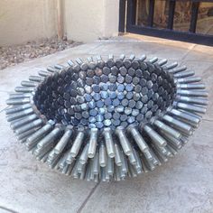 a large metal object sitting on top of a cement ground