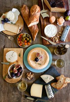 a table topped with bread, cheese and other foods