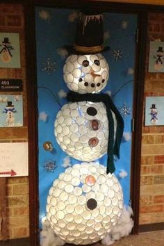 a snowman made out of toilet paper rolls and some other things on the wall