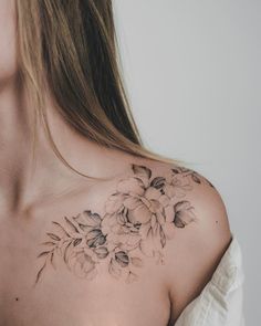 a woman's shoulder with flowers on it, and the back of her chest