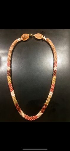 a necklace is shown on a black surface