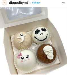 four decorated halloween treats in a box