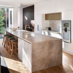 a kitchen with an island counter and wooden floors