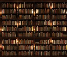 a book shelf filled with lots of books and lit up lights next to each other