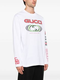 Find GUCCI Logo-print Cotton T-shirt on Editorialist. white cotton lightweight jersey crew neck logo patch to the front logo print to the front long sleeves logo print at the sleeve embroidered logo at the sleeve logo print to the rear straight hem We've partnered with Good On You — an independent agency that rates how brands perform in relation to their impact on the planet, people and animals, with a multi-criteria rating simplified to a five points scale. In order to be awarded our conscious label, larger brands need to score a minimum of four out of five ('Good'), while smaller brands must score at least three out of five ('It's A Start'). This item comes from a brand rated three out of five ('It's A Start') by Good on You at the time it was added on FARFETCH. Please note, this is a br White Sporty Gucci Top, Sporty White Gucci Tops, Sporty Gucci Tops For Streetwear, Long Sleeve T-shirt With Logo For Streetwear, White Gucci Sweatshirt With Logo Print, Sporty Gucci Tops With Letter Print, Gucci Sporty Tops With Letter Print, Gucci Embroidered Logo Long Sleeve Sweatshirt, Casual Gucci Sweatshirt With Embroidered Logo