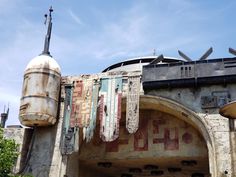 an old building with lots of graffiti on it's walls and some decorations hanging from the roof