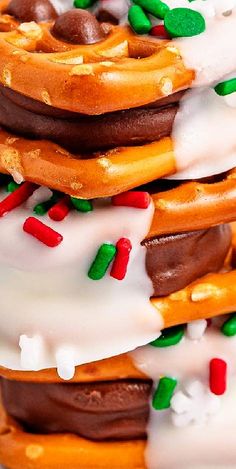 a stack of pretzels covered in white frosting and sprinkles