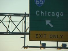 an exit only sign on the side of a highway