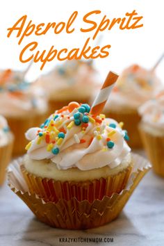 cupcakes with white frosting and sprinkles on top