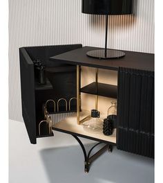 an open cabinet with items in it and a lamp on top