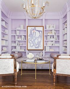 a living room filled with furniture and a chandelier