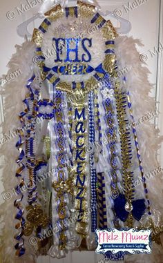 a white and blue mardi gras costume hanging on a door with the words mardi gras written on it