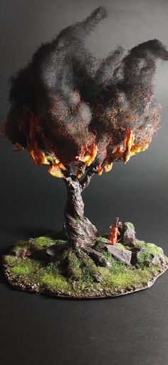 a small tree with flames coming out of it