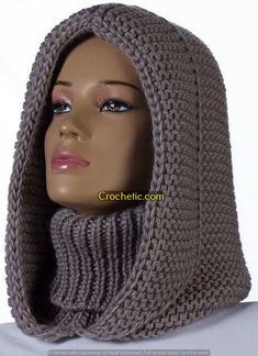 a mannequin head wearing a gray knitted cowl with a hood on it