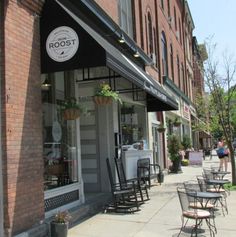 the outside of a restaurant with tables and chairs