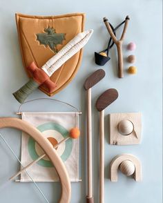 an assortment of wooden toys on a blue surface