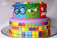 a colorful cake decorated with cartoon characters on it