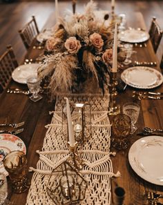 the table is set with white plates and silverware