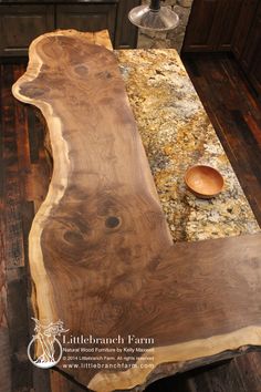 a wooden bench sitting on top of a kitchen counter next to a vase and bowl