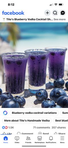 three glasses filled with blueberries sitting next to each other on top of a table