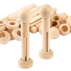 several wooden pegs with holes in them on a white background, including one that has been turned to look like an abacus