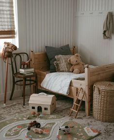 a child's bedroom with teddy bears on the bed and toys in the floor