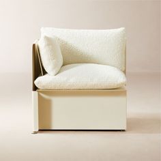 a white chair with a pillow on top of it