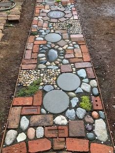 a garden path made out of bricks and stones