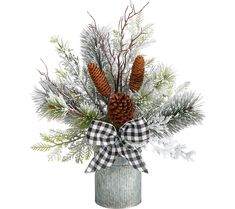 a vase filled with pine cones and evergreen branches