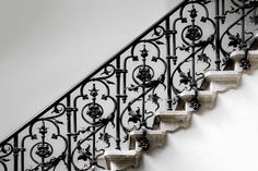 an iron stair rail with decorative designs on it