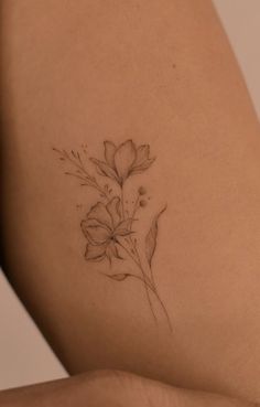 a woman's thigh with a flower tattoo on it