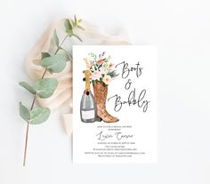 the boots and bridaly wedding card is next to some flowers