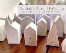 paper houses are lined up on a table with the words printable adventent calendar