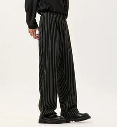 Stride with confidence in our Striped Wide-Leg Palazzo Trousers, where classic tailoring meets contemporary flair.
Crafted from a blend of premium fibers, these trousers boast a sleek striped pattern and a relaxed wide-leg cut, offering style without sacrificing comfort. The fine workmanship is evident in the detailed stitching and thoughtful pocket placement, catering to the relaxed yet sophisticated dresser. 
Pair them with a crisp white shirt for a professional edge or a casual tee for those Luxury Pinstripe Men's Bottoms, Cheap Pinstripe Trousers, Mens Striped Pants, Black Striped Pants, Pin Stripe Pants Outfit, Stripe Pants Outfit, Palazzo Trousers, Pinstripe Pants, Stripe Outfits