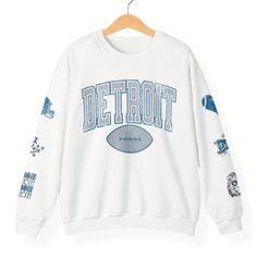 Show off your love for the Motor City with this Detroit Football Sweatshirt. This Detroit crewneck is the perfect game day apparel.  This is a relaxed fit sweatshirt, but true to size. - M A T E R I A L S - Gildan® Sweatshirt 8 oz./yd² (US) 50/50 cotton/polyester Heather Sport colors: 60/40 polyester/cotton Loose Fit Ribbed Knit Collar to retain shape - C A R E  I N S T R U C T I O N S - Inside out, wash with delicate cycle Do not iron directly onto the design Do not bleach Do not dry clean. Varsity Sweatshirt With Graphic Print For Fans, Varsity Graphic Print Sweatshirt For Fan Gear, College Style Crew Neck Tops For Sports Season, College Style Sweatshirt With Graphic Print For Sports Season, Varsity Crew Top With Graphic Print, College Style Game Day Sweatshirt With Graphic Print, College Style Sweatshirt With Graphic Print For Game Day, College Style Graphic Sweatshirt For Game Day, College Style Crew Neck Tops For Sports Events