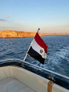 an egyptian flag is flying on the back of a boat in the middle of the ocean