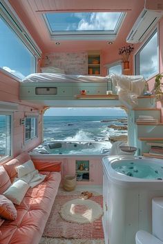 a room with a couch, bed and hot tub in it near the water's edge