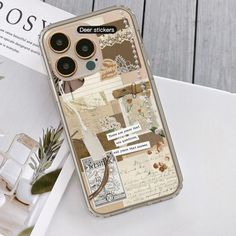 an iphone case with some pictures and writing on the back, sitting on top of a table