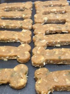 raw dog treats are lined up on a baking sheet in preparation for the freezer