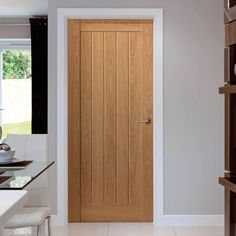 a wooden door sitting inside of a kitchen