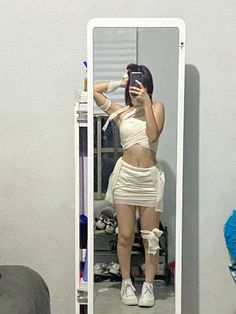 a woman taking a selfie in front of a mirror with her leg wrapped up