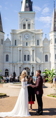 a couple getting married in front of a large building