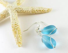 These light blue sea glass earrings are made with high-quality frosted glass that resembles ocean tumbled sea glass, but is much cheaper than ocean tumbled glass. Sea glass style jewelry is consistent in color, size, and shape, so the sea glass earrings you order will look just like the pair in the photos. I make these blue beach glass earrings in either silver plated or sterling silver materials. You can select the material you prefer from the drop-down menu. You can also select the ear wires y Nickel Free Sea Glass For Jewelry Making, Nickel-free Sea Glass Jewelry For Jewelry Making, Minimalist Nickel Free Sea Glass Jewelry, Minimalist Nickel-free Sea Glass Jewelry, Elegant Blue Sea Glass Jewelry, Nickel-free Recycled Glass Drop Earrings, Turquoise Wire Wrapped Sea Glass Jewelry, Turquoise Sea Glass Wire Wrapped Jewelry, Handmade Sea Glass Dangle Jewelry