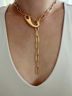 Chunky gold paperclip lariat featuring a large clasp. Necklace can clasp anywhere on the chain for different looks. Necklace is gold plated stainless steel. It is of great importance to me that I make jewelry for my customers that I, myself, wear every day. Each jewelry piece is handmade by me personally with love and care. Each item is crafted to the highest quality and made to exceed the expectations of my customers. My jewelry is designed to you to love and wear no matter what the occasion at Elegant Chunky Chain Lariat Necklace, Elegant Lariat Necklace With Chunky Chain, Metal Lariat Necklace With Chunky Chain, Metal Lariat Necklace With Chain, Metal Lariat Necklace With Chain Detail, Chic Paperclip Chain Lariat Necklace, Chunky Chain Metal Lariat Necklace, Gold-tone Jewelry As A Gift With Hook And Links, Chic Lariat Paperclip Chain Necklace