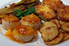 scallops and potatoes on a white plate with sauce