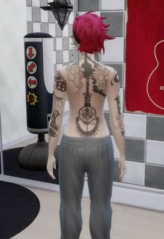 a woman with tattoos on her back standing in front of a mirror