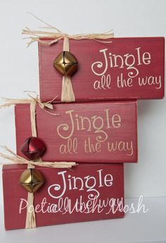 three wooden signs with bells hanging from the top and saying, jingle all the way