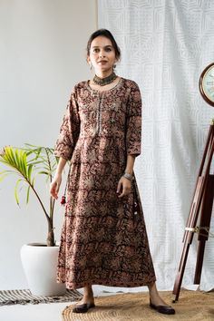 Exemplifying the distinct kalamkari block print, this dress is detailed with mirror work on yoke and tussels on the side. The dress can be wore as kurta for complete look, side tussel both side and side pleats. Kalamkari Dress, Kalamkari Dresses, Kids Designer Dresses, Mirror Work