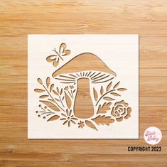 a cutout of a mushroom and flowers on a wooden surface with the words copyprint 2053