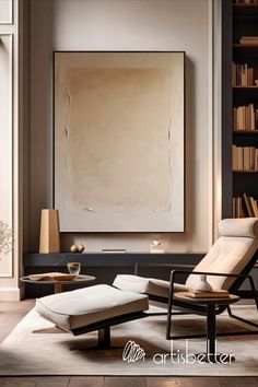 a chair and ottoman in front of a book shelf with a large painting on the wall